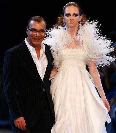 fig.: Georges Chakra Haute Couture fall/winter 2009/10. Georges Chakra and a model greet the crowd after the Georges Chakra Paris fashion show at Cite de l'Architecture et du Patrimoine on 7 July 2009 in Paris, France. Photo by Julien Hekimian/Getty Images for Georges Chakra 2009.